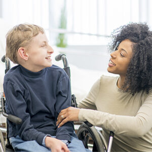 Caregiver talking to little boy.